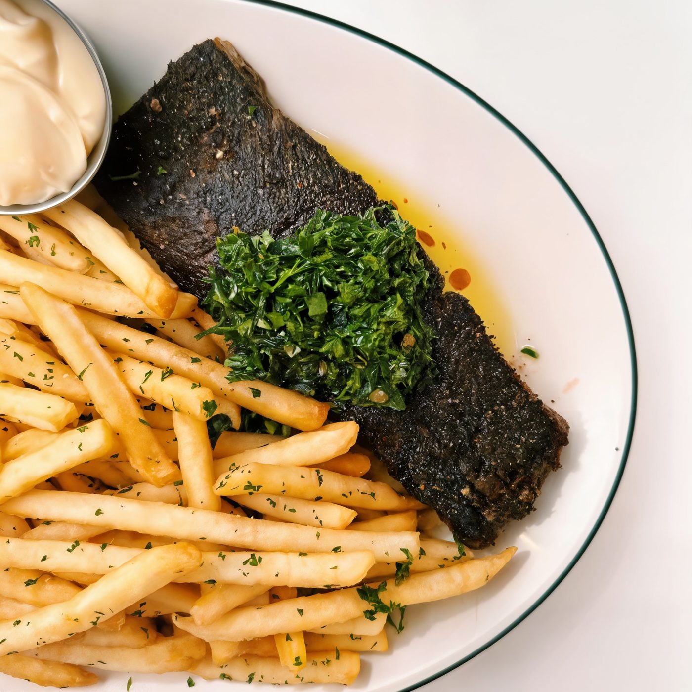 Fish with green herbs, golden fries and creamy sauce