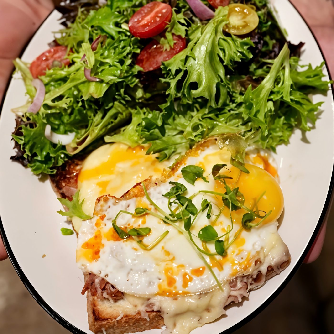 Croque Madame with a fried egg and green salad
